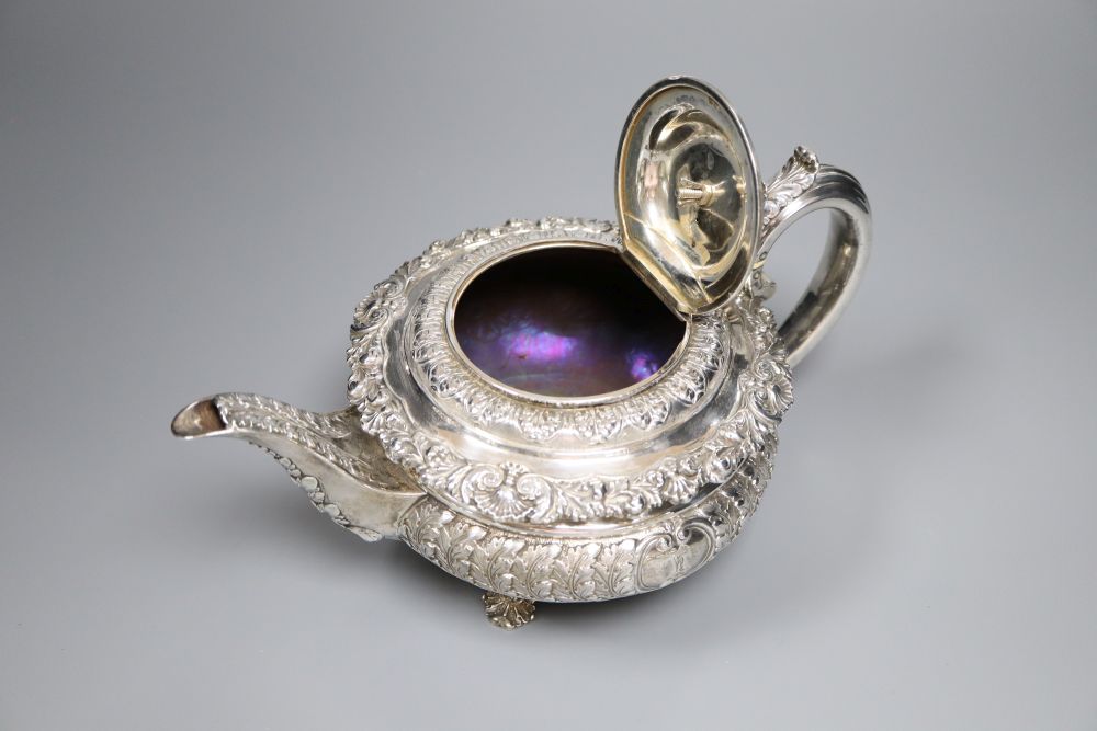 A George IV embossed silver squat circular teapot by Emes & Barnard, London, 1822,